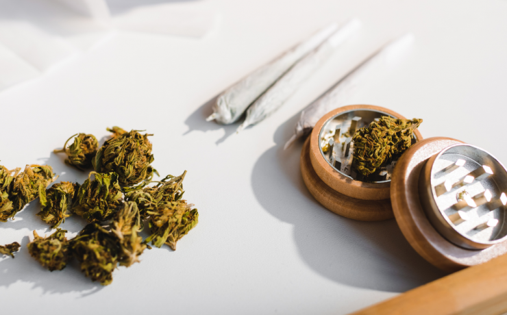 When is Marijuana Possession a Crime in California? - marijuana buds, rolled joints, and herb grinder on a table