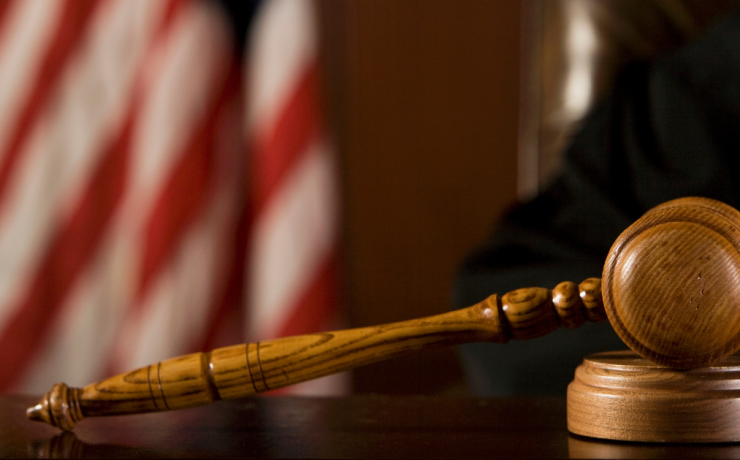 What is the Difference Between Felony, Misdemeanor, and Infraction? Judge's gavel on table with American flag in background