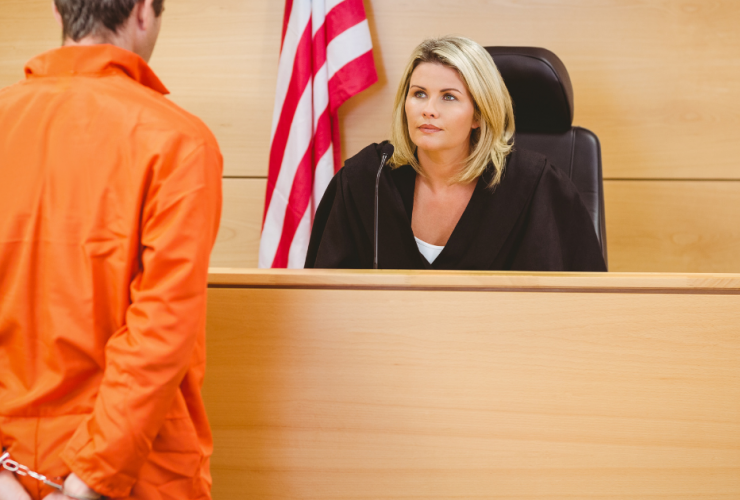 How This New California Law Can Reduce Sentencing Post Conviction - convicted defendant in orange jumpsuit speaking to judge at bench in front of courtroom