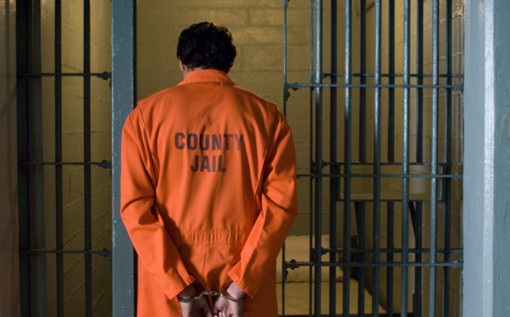 What Does Habeas Corpus Mean? A man wearing an orange jumpsuit goes into a county jail cell