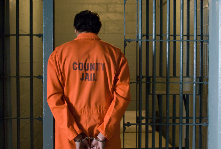What Does Habeas Corpus Mean? A man wearing an orange jumpsuit goes into a county jail cell